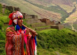 Quetchua_musician_with_Inca_ruins_of_Pisac_in_background_Andes_Mts_Peru_copy